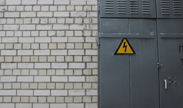 istock Grey Metal Door On A Wall Of Transformer Booth With Triangular High Power Sign 1563339979