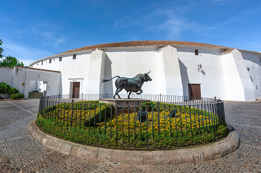 Ronda, Spain - Apr 28, 2019: Plaza de Toros (Ronda Bullring) and Monument to Spanish Fighting Bull - Ronda, Andalusia, Spain