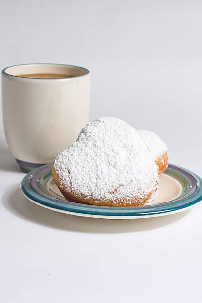 Beignets and Coffee Serving of Coffee and Beignets beignet stock pictures, royalty-free photos & images