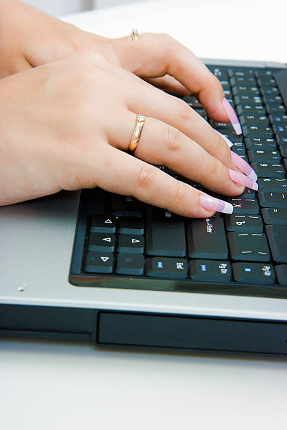 istock Women's hands on the laptop keyboard 156340092