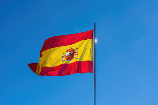 Flag of Spain on a blue sky