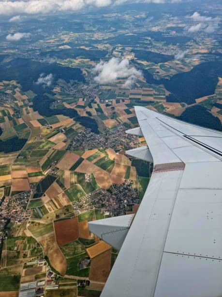 istock Aircraft wing and agricultural fields 1563407610