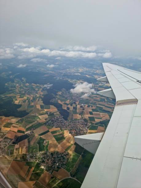 istock Aircraft wing and agricultural fields 1563407613