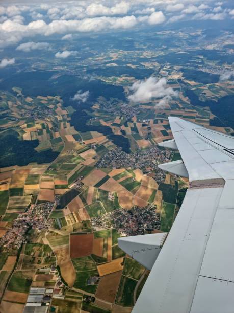 istock Aircraft wing and agricultural fields 1563407618