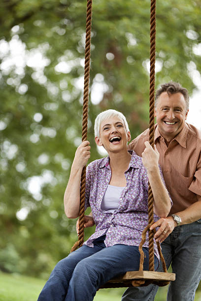 istock Senior Man Pushing his Wife on a Swing 156341429