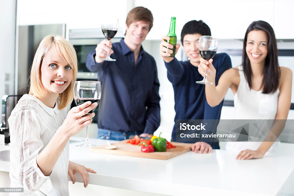 Cheers Cheerful friends toasting while cooking. 20-29 Years Stock Photo