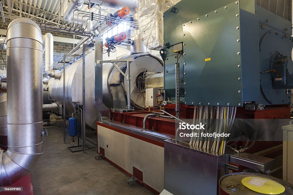 Electric turbogenerator Electric power generator and turbine at modern biomass co generation plant Cable Stock Photo