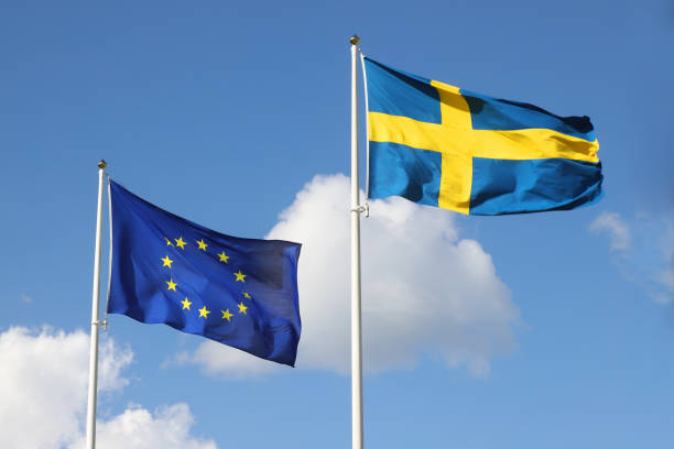 флаги ес и швеции - day sky swedish flag banner стоковые фото и изображения