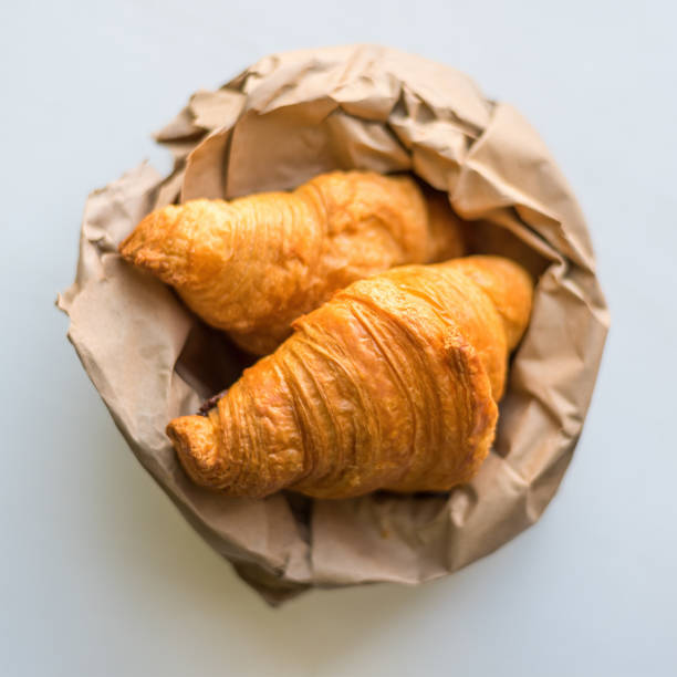 istock croissants in a paper bag on a white background. 1563504900