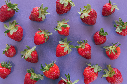 Strawberry on purple background.
