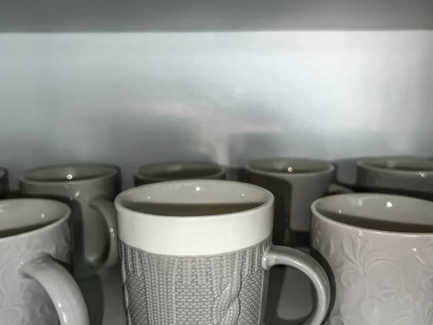 istock Empty single-color porcelain cups standing on a shelf 1563541242