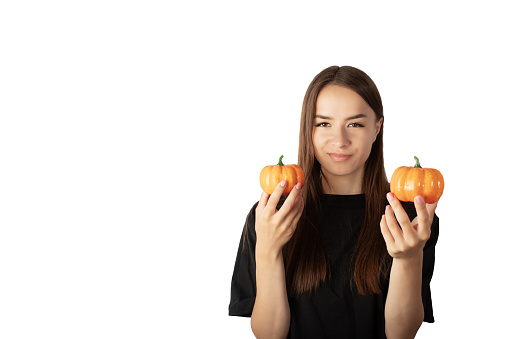 young woman teenager with halloween pumpkins isolated