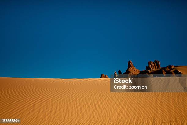 Sand Dune With Rock Formation Stock Photo - Download Image Now - Algeria, Blue, Desert Area