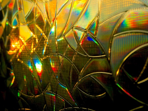 The colorful prismatic light shining through home vanity window film at sunset.