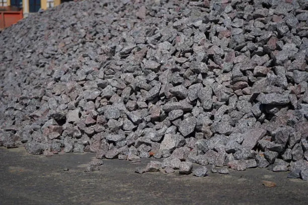 Crushed stone mounds.Grey crushed stones in close up,Versatile building material for horticulture,landscape gardening or road construction,Material for railroad construction
