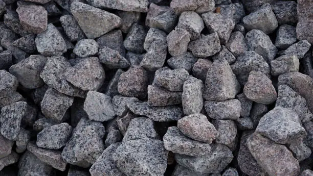 Crushed stone mounds.Grey crushed stones in close up,Versatile building material for horticulture,landscape gardening or road construction,Material for railroad construction