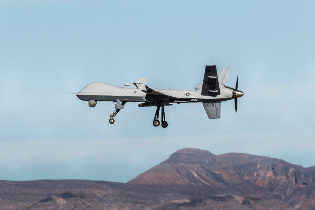 MQ-9 Reaper Drone MQ-9 Reaper Drone flies training mission over Creech Air Force Base in Indian Springs, Nevada. unmanned aerial vehicle stock pictures, royalty-free photos & images
