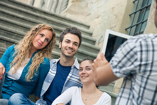 istock Four friends taking pictures together with a tablet 156361915
