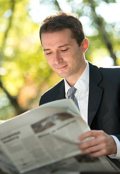 istock Businessman reading newspapers in park 156363031