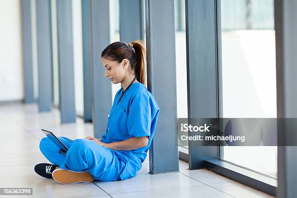 Krankenschwester Auf Dem Boden Sitzen Und Mit Laptopcomputer Stockfoto und mehr Bilder von Arzt