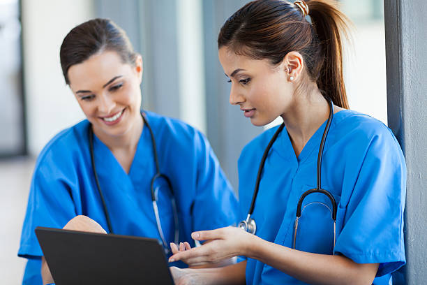 istock beautiful female healthcare workers using laptop 156363969