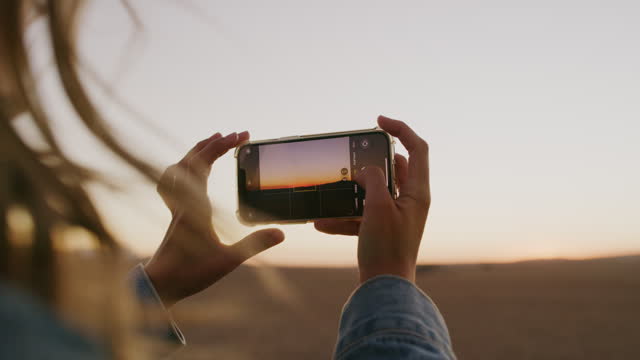 Hand, phone and woman photographer in nature, relax and taking photo of journey or road trip. Social media, photography and female traveling influencer in countryside for profile picture or blog post