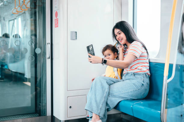 istock Asian Mother and son traveling by train 1563659350