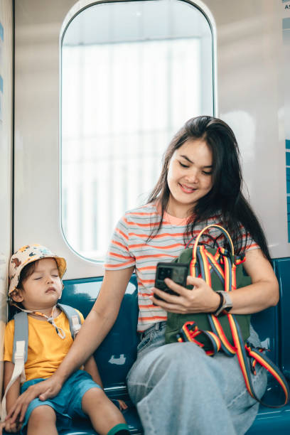 istock Asian Mother and son traveling by train 1563679646