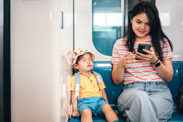 istock Asian Mother and son traveling by train 1563681846