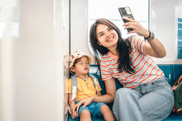 Asian Mother and son traveling by train