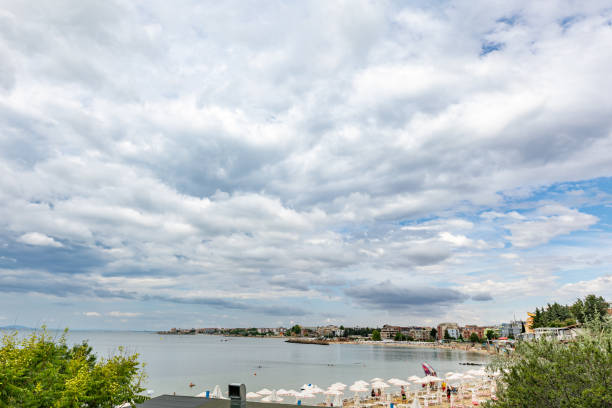 In Nesebar, located on the Southern Bulgarian Black Sea coast, you'll find beach chairs and white umbrellas adorning the sandy shores.