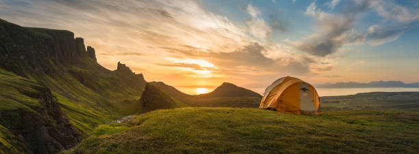 istock Mountain tent sunrise dawn on idyllic camp panorama 156378562