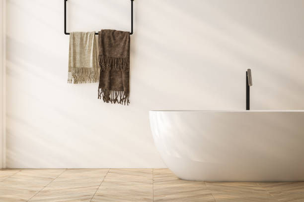 istock Bright bathroom interior with bathtub, parquet floor. 1563787070