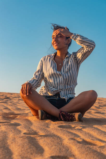 istock Windswept Wonder: Young Latina Woman Amidst Desert Dunes 1563829372