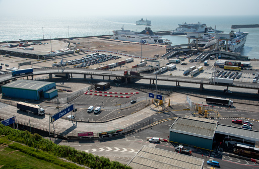 Dover, United Kingdom, June 09 2023 : Trucks and ferries on port of Dover. Dover harbour connects Europe with United Kingdom and handles passengers, vehicles and cargo.