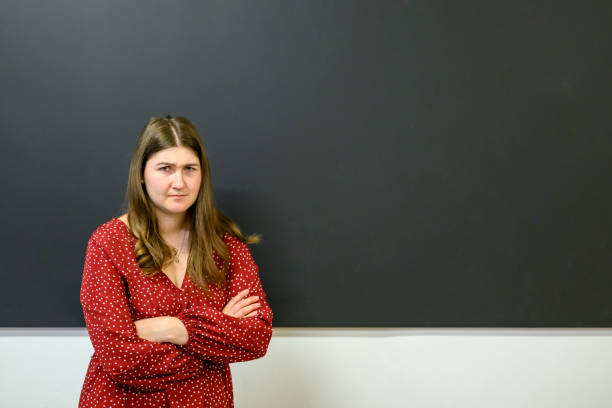 istock Angry teacher standing at the blackboard 1563842096