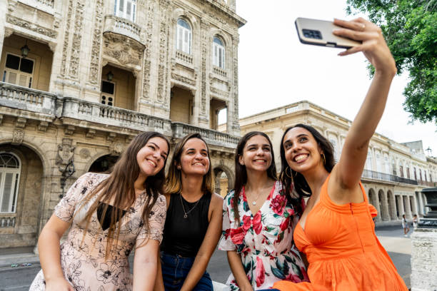 Young friends taking selifes in Havana, Cuba