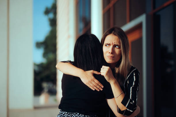 istock Envious Woman Hugging Her Friend Feeling Skeptical 1563859093