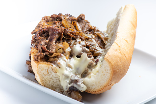 homemade cheese steak sandwich isolated on white background