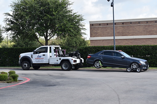 Houston, TX USA, July 21, 2023 - A blue Mercedes-Benz C Class being towed at Sewell Mercedes in Houston