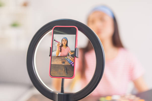 istock Young woman recording a makeup video 1563908946