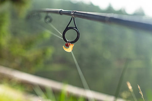 Selective focus fishing rod and lure bokeh outdoor backgrounds
