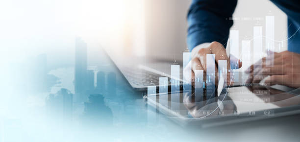 istock finance with a professional businessman use using laptop and tablet analyzing financial data, graph growth chart in action. perfect business plan, strategy, and solution. 1563985326