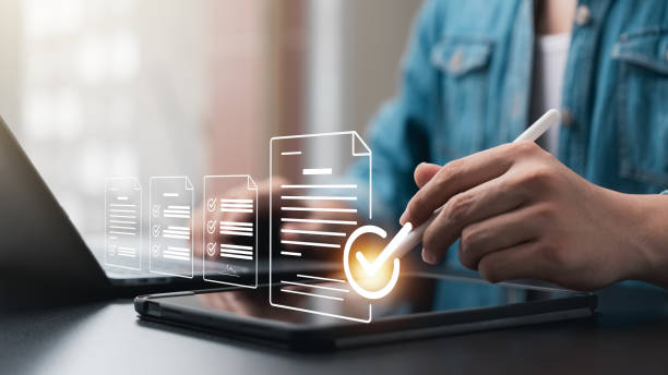 istock Elevate your business performance with online surveys, exams and evaluations, Watch as a professional businessman uses checklists to drive success and growth. Discover the power of assessment today 1563985375