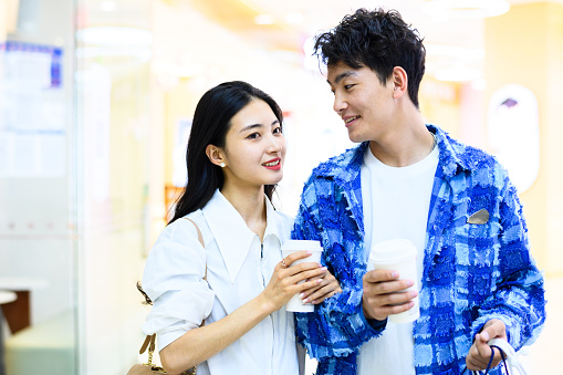 Asian young couple shopping in shopping mall