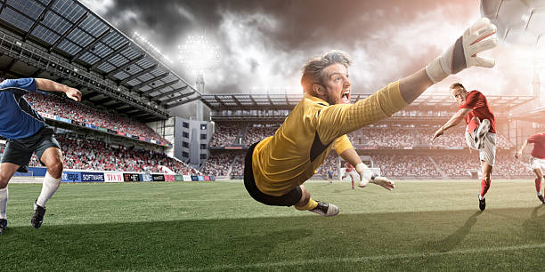 istock Goalkeeper Dives to Make Heroic Save 156405682