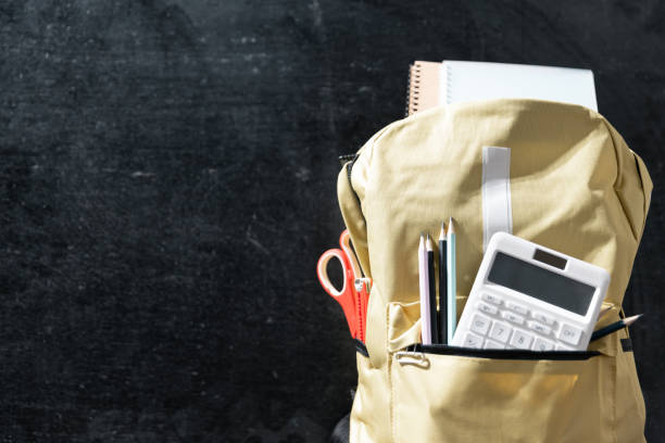 istock Back to school background with books on wooden table over chalkboard 1564124652