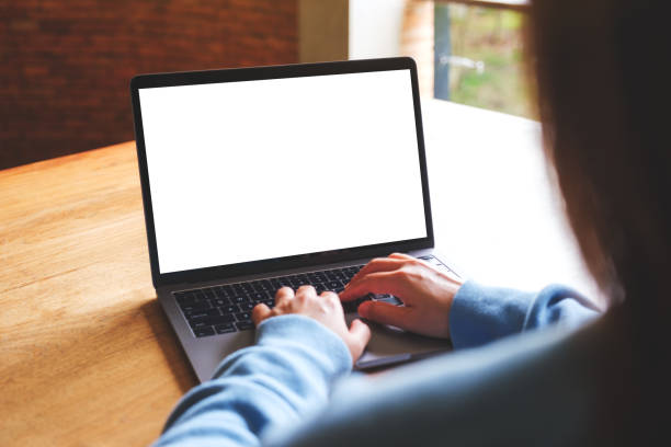 istock Mockup image of a woman using and working on laptop computer with blank white desktop screen 1564145059