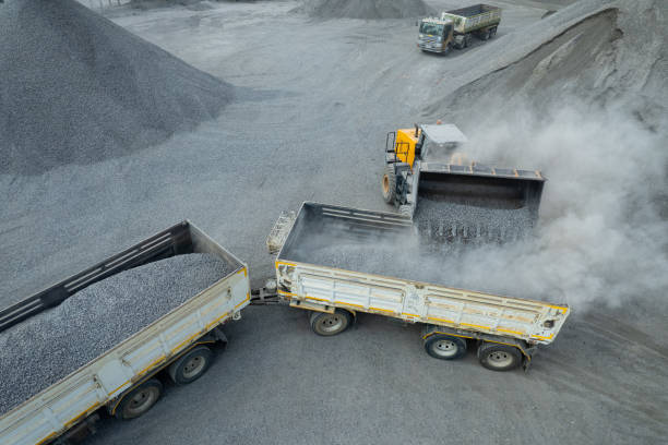istock Sand loaders are shoveling rocks into dump trucks. 1564153228