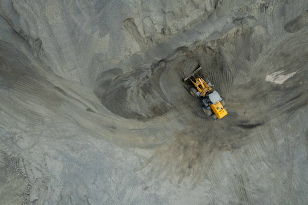 istock Sand loaders are shoveling rocks into dump trucks. 1564153486